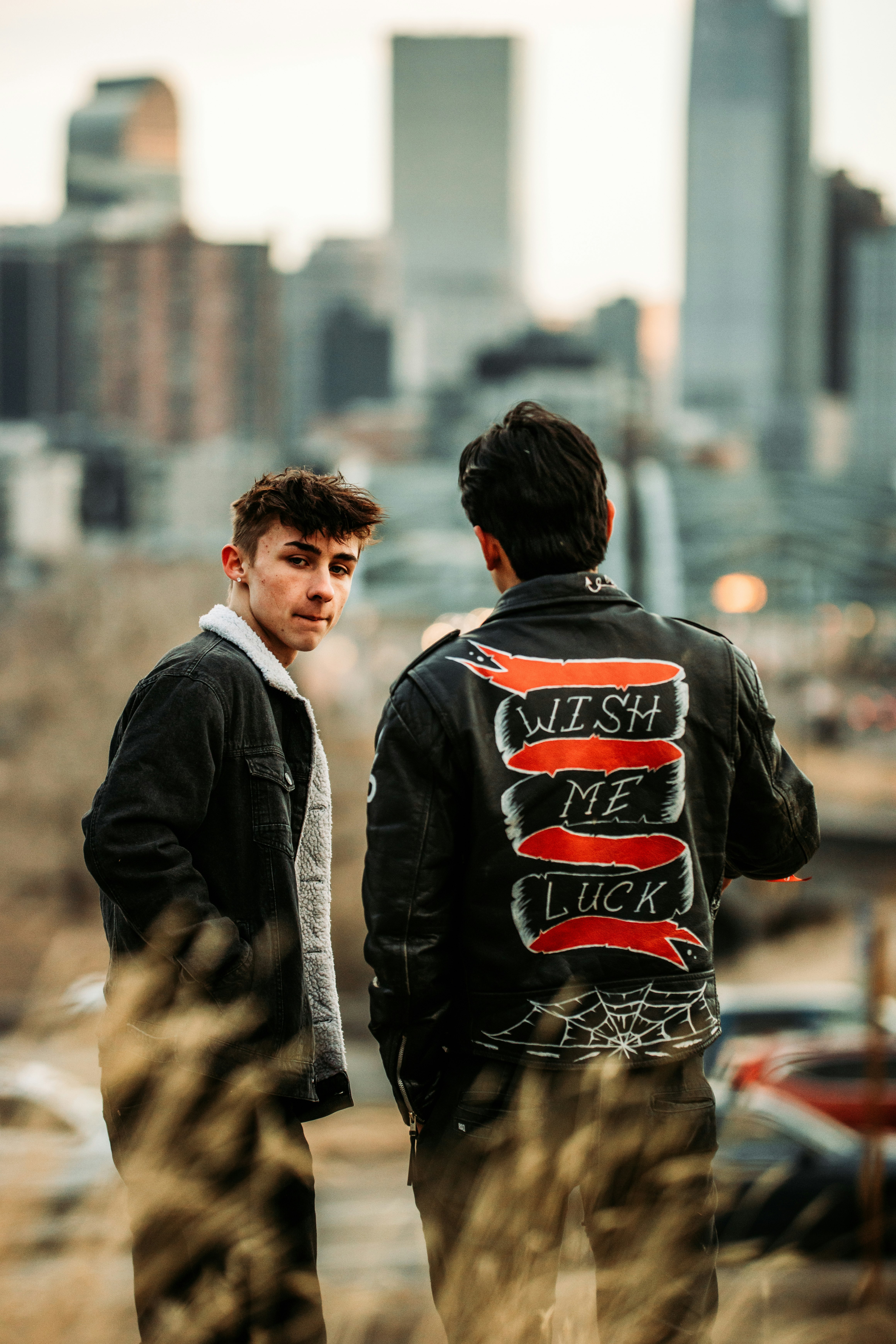 man in black leather jacket standing beside woman in black jacket